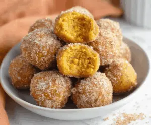 Delicious homemade Bisquick pumpkin donut holes dusted with cinnamon and powdered sugar, perfect for fall treats