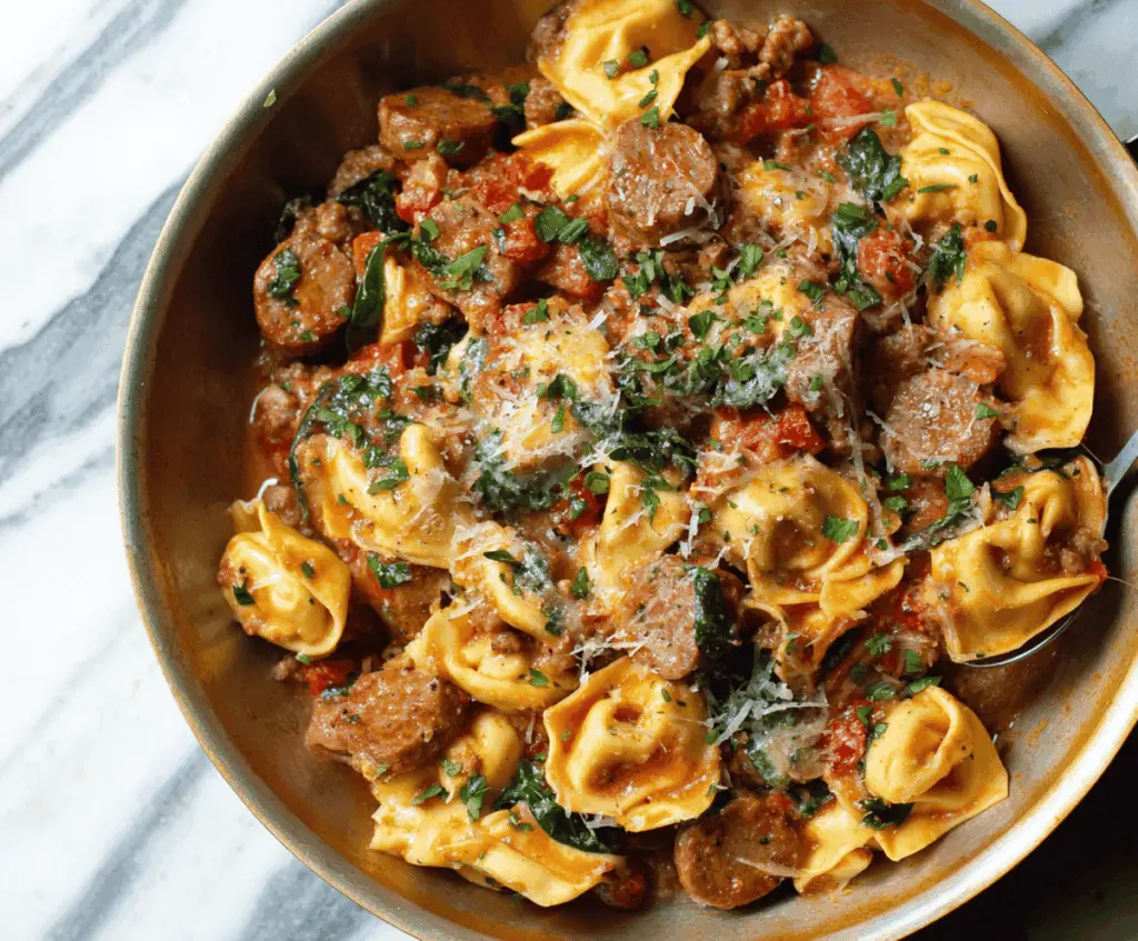 Delicious one pan tortellini with sausage and vegetables served in a skillet, ready to enjoy