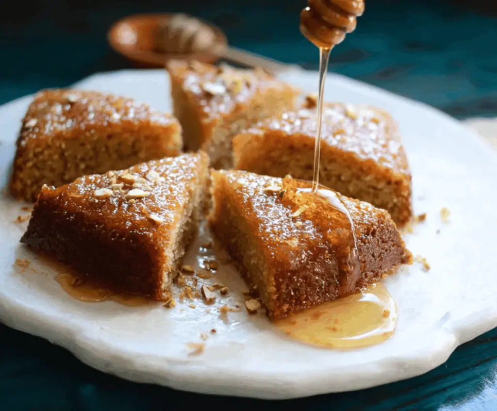 Delicious Greek Honey Cake garnished with honey and walnuts on a rustic plate