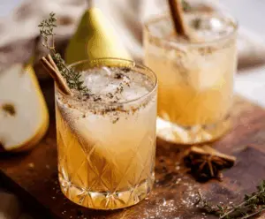 Refreshing vanilla pear mocktail in a glass garnished with pear slices and mint for cozy autumn sipping