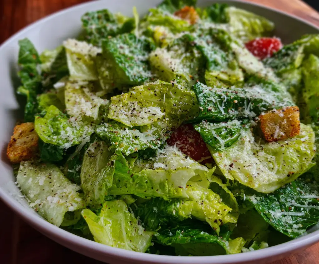 Fresh Nana's Crunchy Lemon Parmesan Salad with vibrant greens, grated Parmesan, and tart lemon slices.