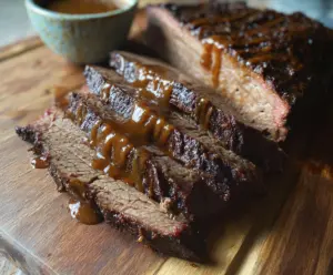 Juicy slow cooker brisket with crispy edges, served on a rustic wooden table.