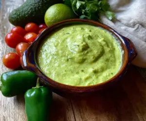 Creamy tomatillo and avocado salsa in a bowl, perfect for dipping or topping dishes.